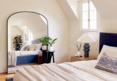 Full-length mirror beside a wardrobe in a modern bedroom